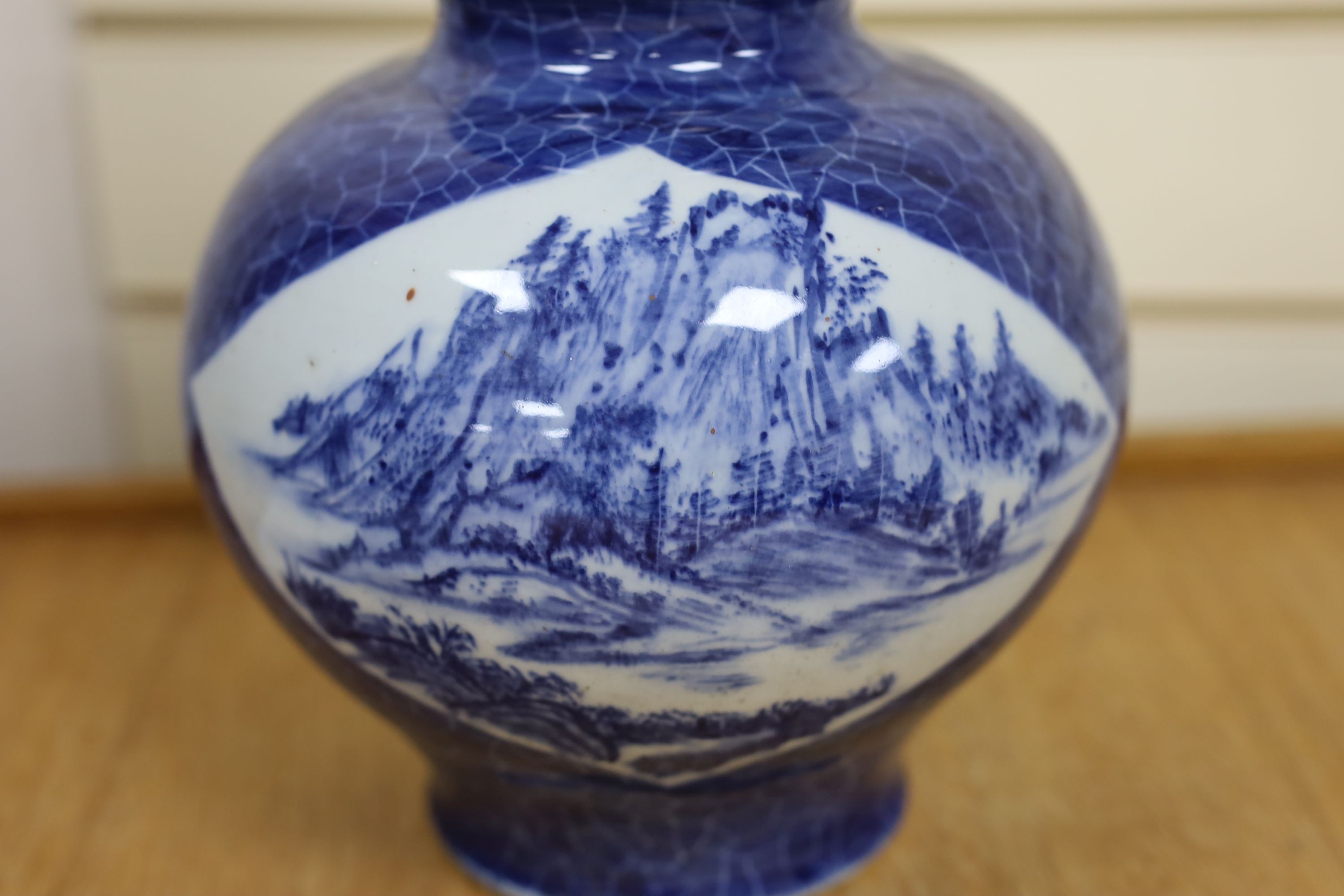 A Chinese blue and white gourd vase with landscape decoration, a similar blue and white sleeve vase and a Japanese Kutani vase